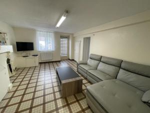 a living room with a couch and a coffee table at Gîte Vineuil, 4 pièces, 6 personnes - FR-1-491-424 in Vineuil