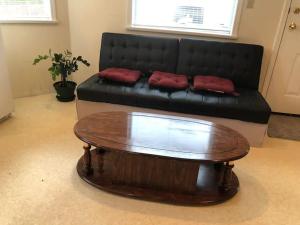 a living room with a couch and a coffee table at Cozy 1 bedroom 1 bath guest suite in a house in Burnaby