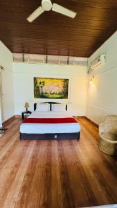 a large bedroom with a bed and a ceiling at Coorg Heritage Hill View Resort in Madikeri