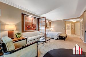 a hotel room with a bed and a couch at MGM Signature-08-803 F1 Track & Strip View Studio in Las Vegas +27 photos