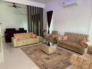 a living room with two couches and a table at Live Well Homestay Senawang in Seremban