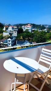 a surfboard and a chair on a balcony at Mộc Nhiên Villa in Da Lat +12 photos