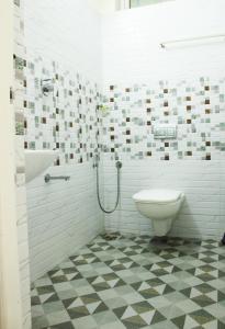 a white bathroom with a toilet and a shower at Lavender Plantation Stay vagamon in Vagamon