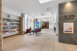 a lobby of a hospital with a table and chairs at 'Tropical Escape' Coastal Daydreams with Rooftop Spa in Palm Cove +53 photos