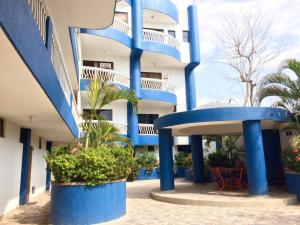 a building with blue columns and plants in front of it at Apt 311 Mar de leva in Santa Marta