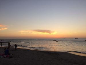 a group of people on the beach at sunset at Apt 311 Mar de leva in Santa Marta