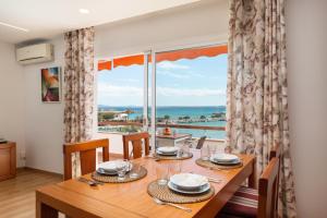 a dining room with a table and a large window at Apartment Antonia - Alcúdia in Alcudia