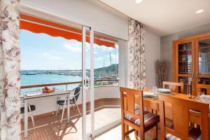 a dining room with a view of the water at Apartment Antonia - Alcúdia in Alcudia