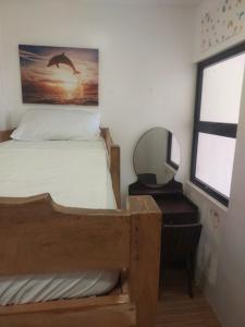 a bedroom with a bunk bed and a mirror at Frozen 2 in Puerto Princesa City