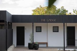 a building with a sign that reads the lodge at The Lodge - 4 Luxury Central Private Studio Rooms - Free wifi in Mount Gambier