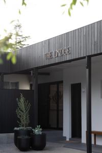 a building with a sign that reads the lodge at The Lodge - 4 Luxury Central Private Studio Rooms - Free wifi in Mount Gambier