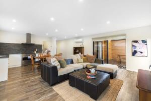 a living room with a couch and a table at Grandview Lodge in Wanaka