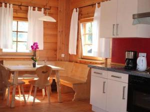 a kitchen with a table and chairs in a cabin at Pleasant apartment in Naturns in Naturno