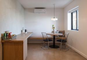 a kitchen with a table and chairs in a room at Best Bet Motor Lodge in Reno