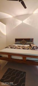 een bed in een kamer met een plafondventilator bij Aanegudda homestay and easystay in Kalasa