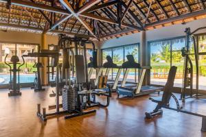 einen Fitnessraum mit mehreren Laufbändern und Heimtrainern in der Unterkunft Vg Sun Condominio pe na areia estilo resort in Caucaia
