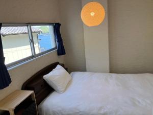 Ein Bett oder Betten in einem Zimmer der Unterkunft Oninosanpomichi