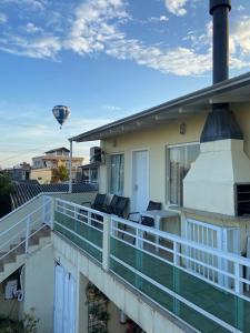 een balkon van een huis met een luchtballon in de lucht bij Apartamento em Torres in Torres