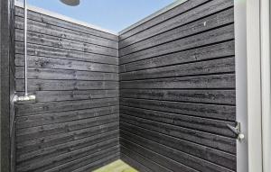 a bathroom with a wooden wall at Four-Bedroom Holiday Home In Haderslev in Haderslev +22 photos