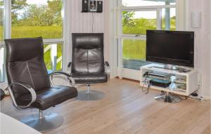 ein Wohnzimmer mit 2 Stühlen und einem Flachbild-TV in der Unterkunft Awesome Home In Sydals With 3 Bedrooms, Sauna And Wifi in Østerby