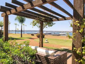 a pergola with a view of the beach at Alugueasy - Brisas do Lago in Brasilia