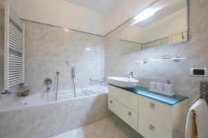 a bathroom with a sink and a bath tub and a sink at Suite 22 - Happy Rentals in Riva del Garda