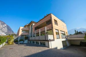a large building with mountains in the background at Suite 22 - Happy Rentals in Riva del Garda +14 photos
