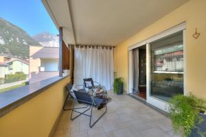 a balcony of a house with a chair and a window at Suite 22 - Happy Rentals in Riva del Garda