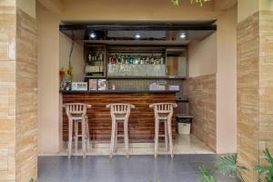 a bar with three stools in a restaurant at Dream @ Jimbaran in Jimbaran