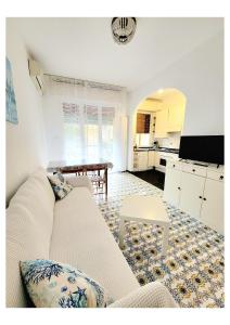 a living room with a white couch and a table at Sail Away Camogli in Camogli