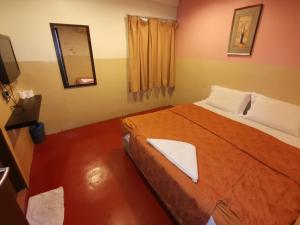 Postel nebo postele na pokoji v ubytování HOTEL BINTANG