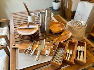 a wooden tray with wooden utensils on a table at TAITO BEACH HOUSE in Ichigaya