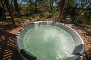 a metal tub filled with water on a deck at The Treehouse at Sellicks Hill in Sellicks Hill