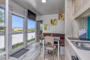 a kitchen and dining room with a table and chairs at Rooftop Home With Whirlpool & Sauna in Trebnje