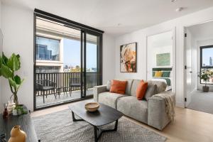 sala de estar con sofá y mesa en Urban Rest Richmond Apartments en Melbourne