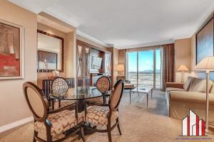 a living room with a table and chairs and a couch at MGM Signature-37-814 1Br 2Ba F1 Pits View Balcony in Las Vegas