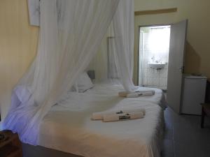 a bedroom with a white bed with two towels on it at ANSTA SELF CATERING Home in Outjo