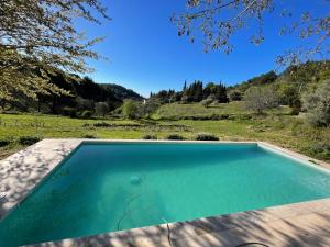 a swimming pool with a view of a field at Maison à la Naronne in Bandol