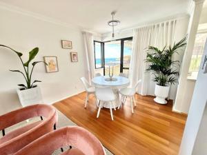 a dining room with a table and chairs in a room at Dolce Vista - North Beach Coastal Haven in Perth