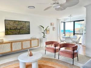 a living room with a table and chairs at Dolce Vista - North Beach Coastal Haven in Perth