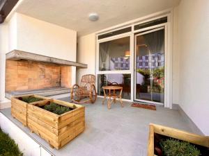 a patio with a fireplace and a table and chairs at Coastal villa with private garden in Porto Santa Margherita di Caorle +14 photos