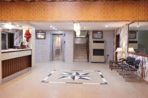 a lobby with a star pattern on the floor at National Hotel in Lahore