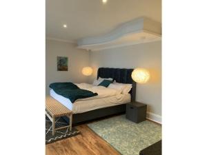 a bedroom with a bed with a green blanket at Sunshine Modern Retreat in Port Alfred