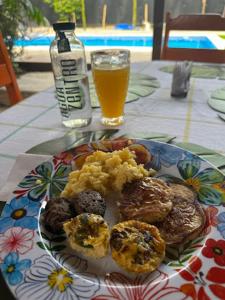 a plate of food on a table with a glass of beer at Mecca in Puerto Viejo