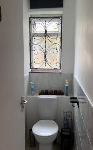 a bathroom with a white toilet and a window at Wembley Stadium in London