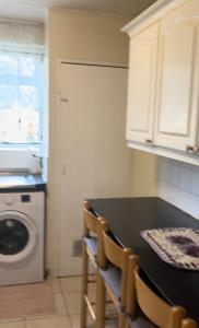 a kitchen with a table and a washing machine at Wembley Stadium in London
