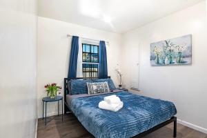 a bedroom with a bed with two towels on it at Chic Studio Sleeps 4 Beverly Hills Adj in Los Angeles