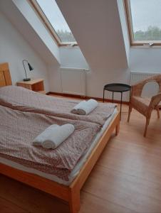 a bedroom with a bed with two pillows on it at Stadnina Koni Nad Wigrami in Mikolajewo