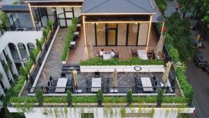 an aerial view of a house with a deck with chairs at Indigen Boutique Hotel Cao Bang in Cao Bằng