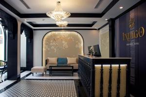 a living room with a couch and a chandelier at Indigen Boutique Hotel Cao Bang in Cao Bằng